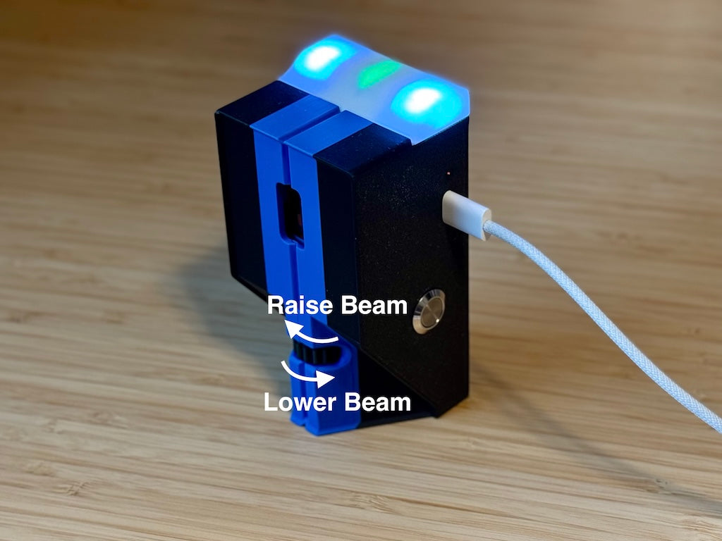 SmartBeam's front rotary dial, with arrows showing the directions to raise and lower the beam